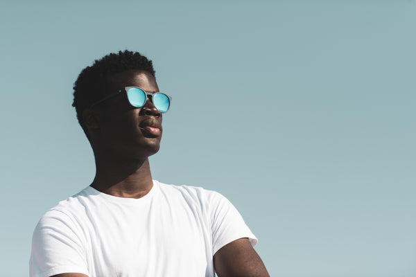 Man wearing white t-shirt and blue polarised sunglasses
