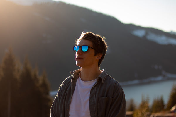 Man looking up to Ski slopes in polarised sunglasses